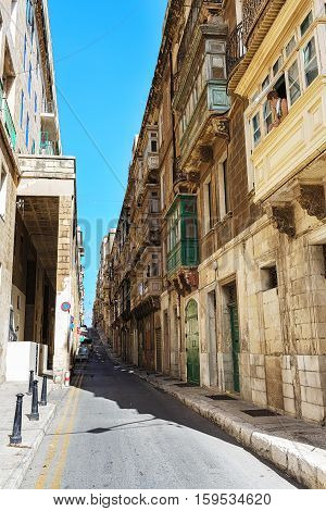 Balconies in Malta on the stone facade of historical townhouses