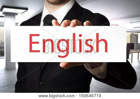 businessman in modern office holding sign english