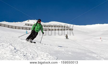 Male Skier Skiing On Ski Slope