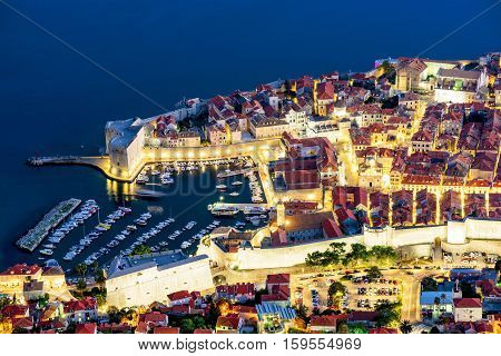 Aerial view of Dubrovnik old town with harbor at night
