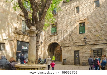 Tourists Looking For Direction In Plaza De Sant Felip Neri In Gothic District In Barcelona, Spain.
