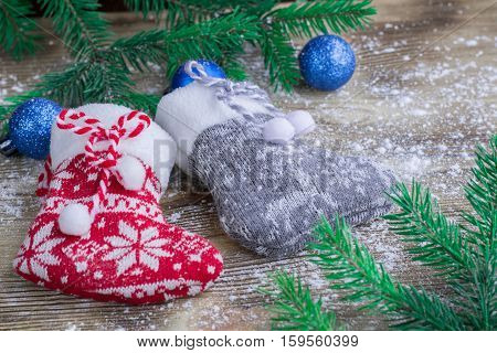 Christmas Stockings Pair On Snowbound Wooden Background With Blue Balls