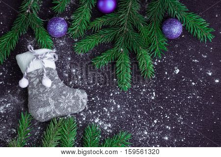 Grey Christmas Stocking On Snowbound Black Background With Purple Balls