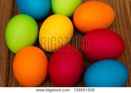 colorful easter eggs on wood brown background