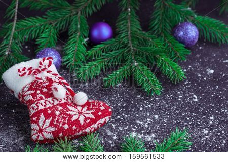 Christmas Red Stocking On Snowbound Black Background With Purple Balls