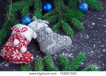 Two Christmas Stockings On Snowbound Black Background With Blue Balls