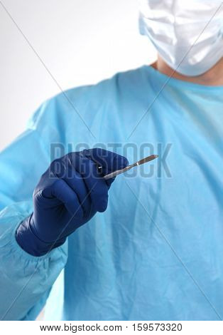Surgeon hand hold scalpel and tweezers while cut and cure wound closeup. Resuscitation and or, injury heal, medic shop or store, saving patient, 911, surgery and emergency, put stitch concept