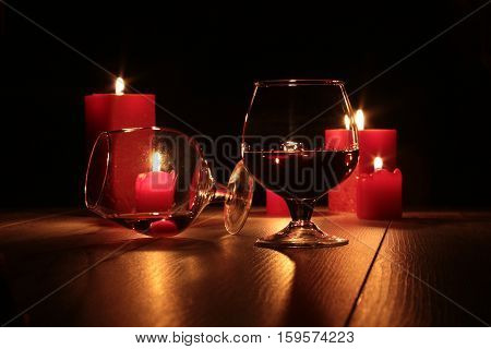 christmas composition photo cognac glass and candle on black background.