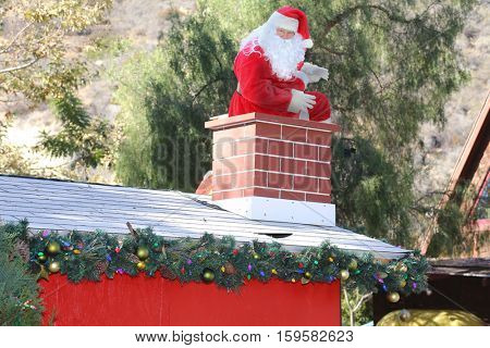 Santa Claus enters a home through the Chimney bringing his bag of toys and gifts for all the good boys and girls.
