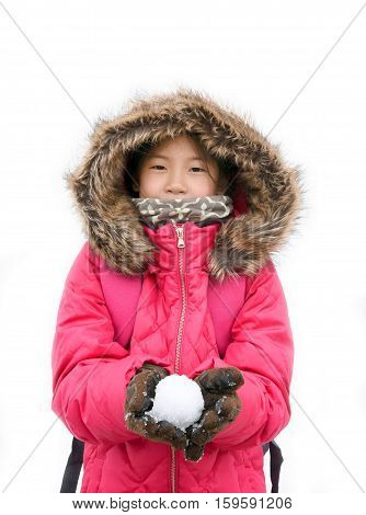 Young happy Asian girl in pink jacket with furry hood holding snowball murodo Tateyama Kurobe Alpine Japan. Asian model preteen in shocking pink down jacket Isolated on white background.