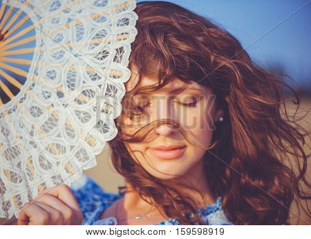 Girl With A Fan By The Sea