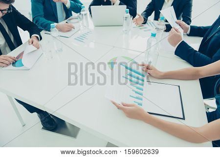 Close Up Of Young Managers Analyzing Diagramas On Business Meeting