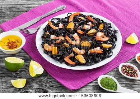 Black Noodles With Prawns And Mussels On White Dish