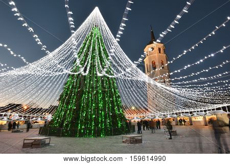 VILNIUS LITHUANIA - NOVEMBER 28: Night view of the christmas tree in Vilnius on November 28 2016 in Vilnius Lithuania. In 1994 the Vilnius Old Town was included in the UNESCO World Heritage List.