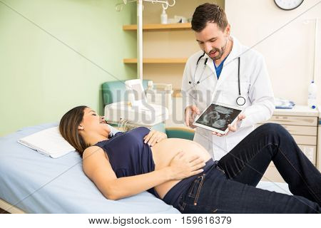 Doctor Showing Ultrasound On A Tablet