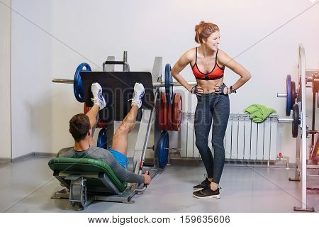 Fitness Man Shakes His Legs With The Girl Coach