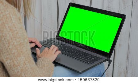 Woman using laptop with green screen. Business, communication, freelance and internet concept