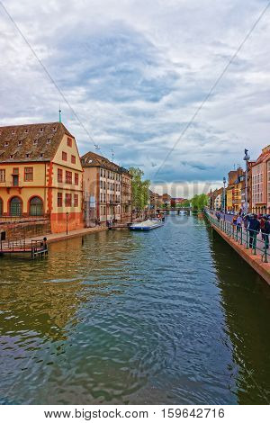 Strasbourg France - April 30 2012: Historical Museum at the waterfront of Ill River Bridge in the old town in Strasbourg Grand East region in France. People on the background