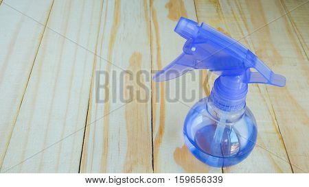 Spray bottle for spit hair in the salon on wooden
