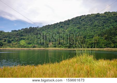 Beautiful landscape of the Laguna Verde with a boat in Apaneca Ruta de Las Flores itinerary El Salvador Central America.