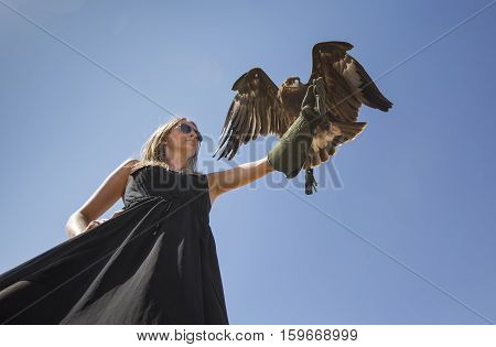 Young woman with Greater Spotted Eagle (clanga clanga)