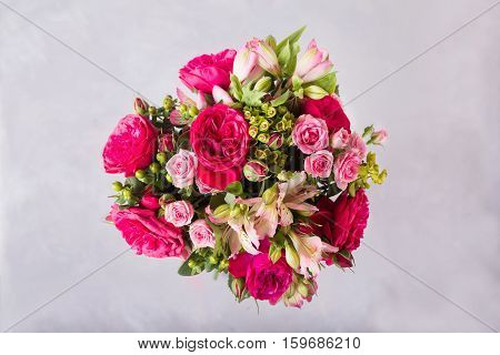 Bouquet of red, pink roses and pink peonies, alstroemeria. . Still life with colorful flowers. Fresh roses. Place for text. Flower concept. Fresh spring bouquet. Summer Background