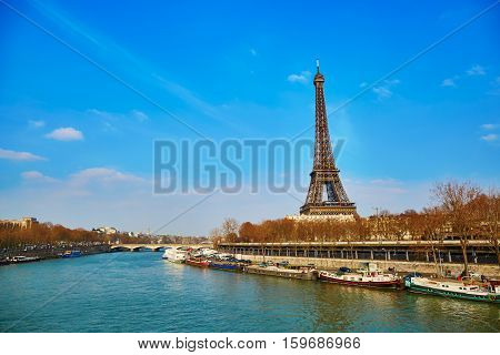 Scenic view of the Eiffel tower across the Seine on an early spring day
