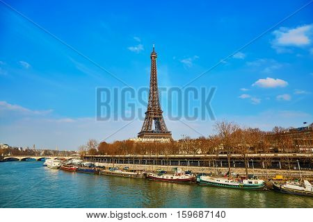 Scenic view of the Eiffel tower across the Seine on an early spring day
