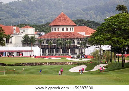 KUALA LUMPUR, MALAYSIA - OCTOBER 29, 2016: LPGA golfers play on the green opposite the clubhouse of the TPC Golf Course at the 2016 Sime Darby LPGA Malaysia golf tournament.
