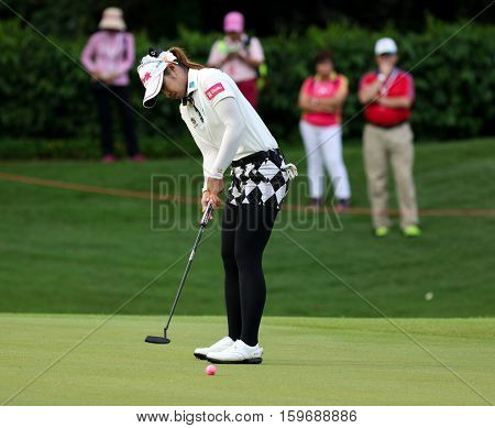 KUALA LUMPUR, MALAYSIA - OCTOBER 29, 2016: Pornanong Phatlum of Thailand putts on the green of the TPC Golf Course on Round 3 of the 2016 Sime Darby LPGA Malaysia golf tournament.