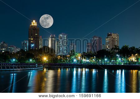 Super full moon over the modern building on Nov 14 2016 in bangkok Thailandby composition image technique