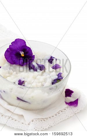 Risoto prepared with petals of violet. Isolated on white background.