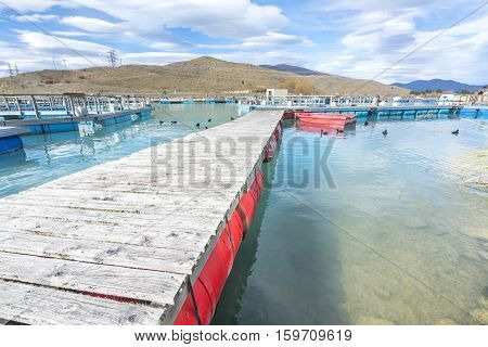 Salmon Fish farm floating on the glacial waters of Wairepo Arm Twizel South Island New Zealand