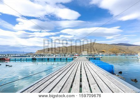 Salmon Fish farm floating on the glacial waters of Wairepo Arm Twizel South Island New Zealand