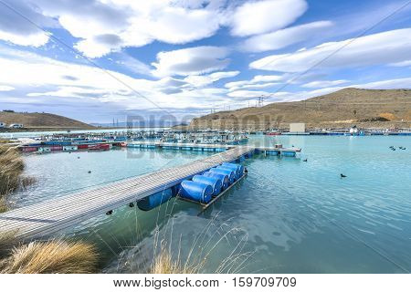 Salmon Fish farm floating on the glacial waters of Wairepo Arm Twizel South Island New Zealand