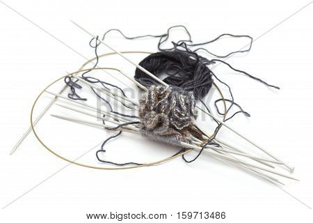 making knitted pompom with many needles isolated on white