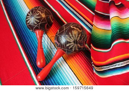 Mexico poncho serape traditional cinco de mayo rug maracas fiesta background with stripes copy space