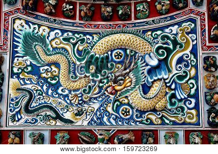 Bang Pa-In Thailand - December 28 2009: Detail of the ceramic Dragon Screen at Phra Thinang Wehat Chamrun Chinese Pavilion at the Bang Pa-In Royal Summer Palace
