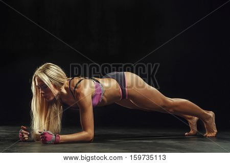 beautiful sexy sports girl on a dark background