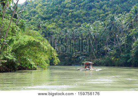 Outrigger boat on a tropical river in South-East Asia