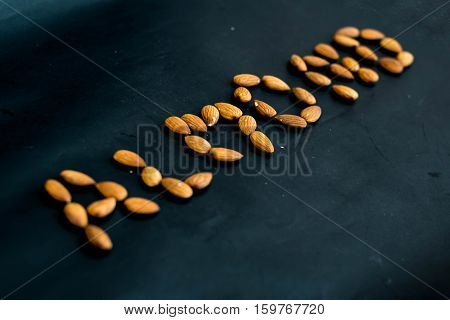close up almonds nuts on black backgroundselective focus.