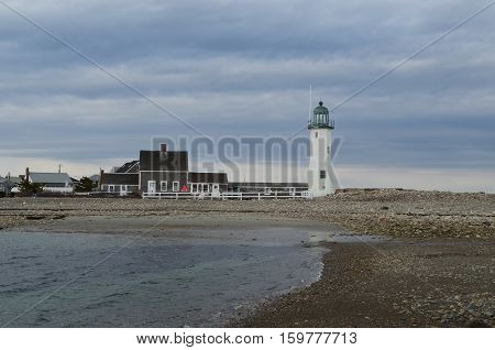 Picturesque views of Old Scituate Light on a rocky beach.