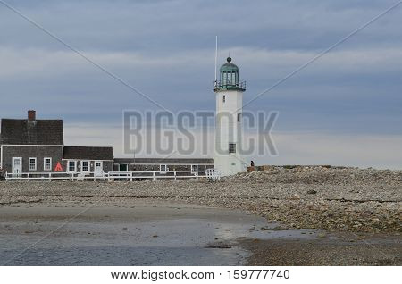 Old Scituate Light and rocky coast in Scituate harbor in Massachusetts.