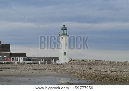 Rocky shore with Old Scituate Light in Southeastern Massachusetts.