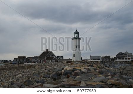Scituate Light with large rocks on a Scituate beach.