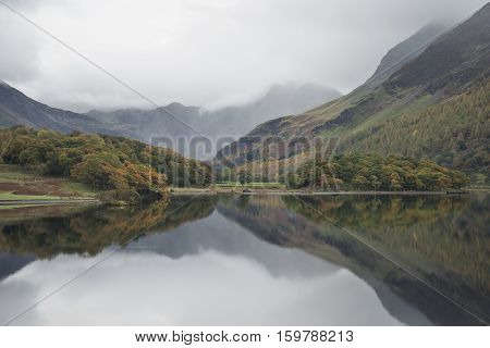 Beautiful Autumn Fall Landscape Image Of Crummock Water At Sunrise In Lake District England