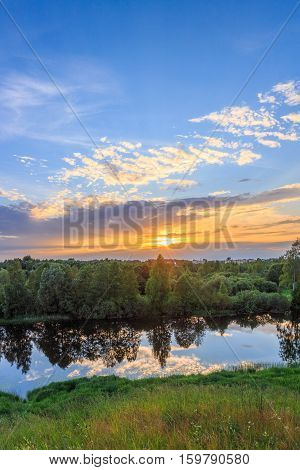 Multicolor sunset over a small river, vertical shot