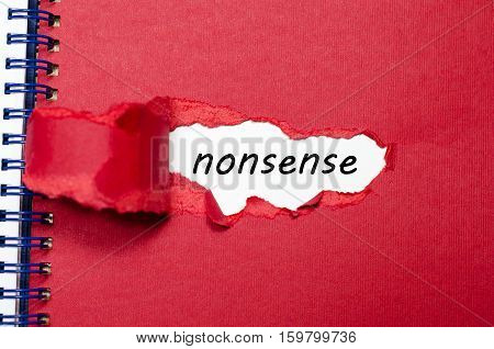 The word nonsense appearing behind torn paper