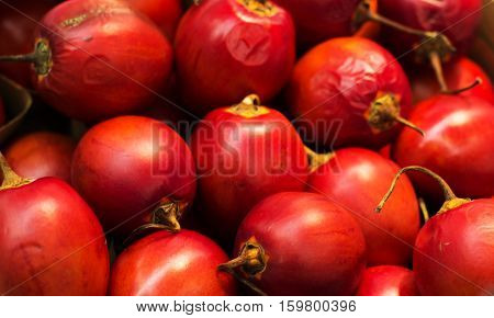 a lot of tamarillo red exotic fruit