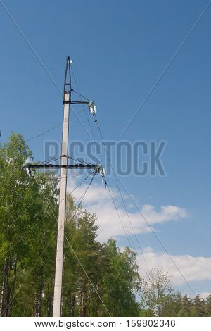 High-voltage electric main against the dark blue sky in summer day